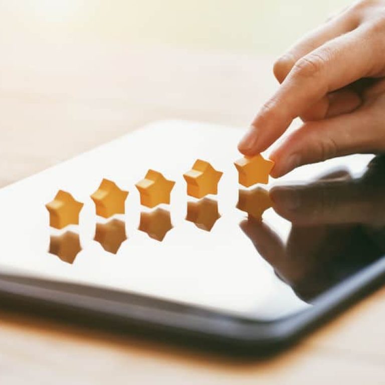 hand gives five stars rating as product feedback with tablet computer