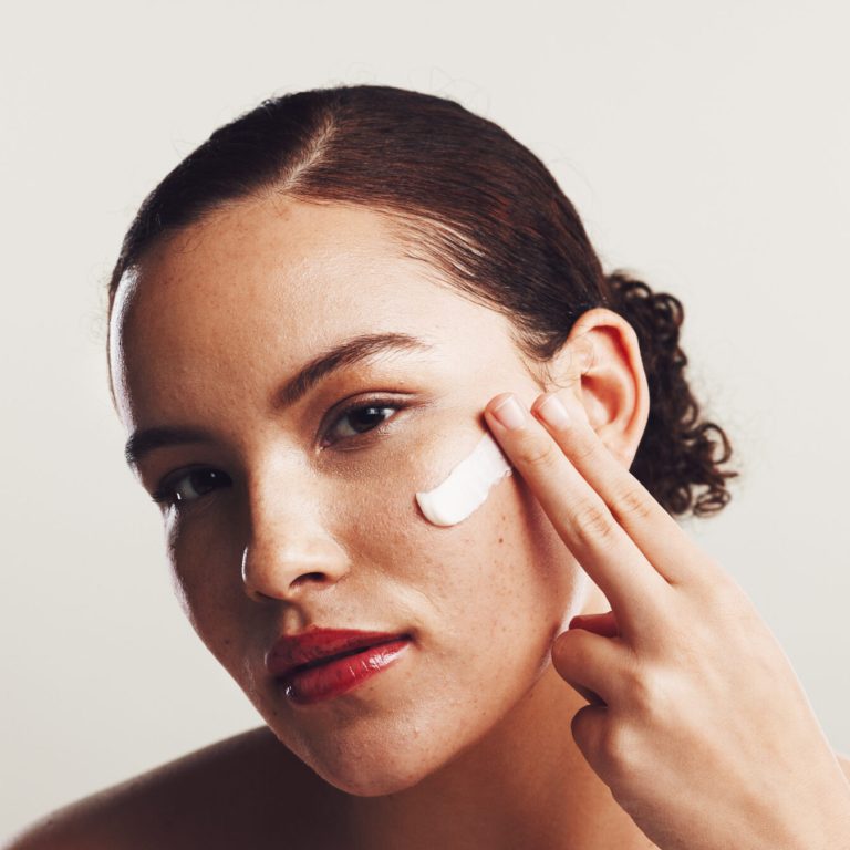 Portrait, cream and woman with skincare, cosmetics and dermatology on white studio background. Face.
