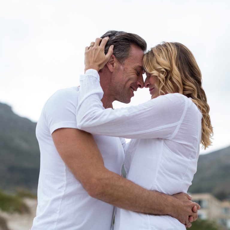 Romantic mature couple embracing each other on the beach
